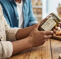 Customer reading the label on a Stone & Honey jar